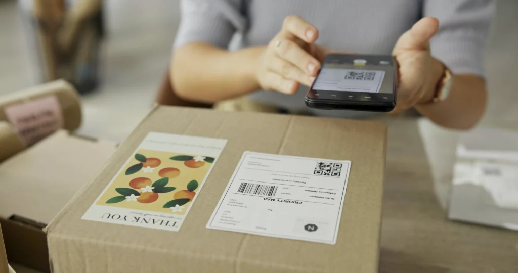 woman-hands-and-phone-to-scan-package-for-dropshi-2024-07-11-20-58-42-utc
